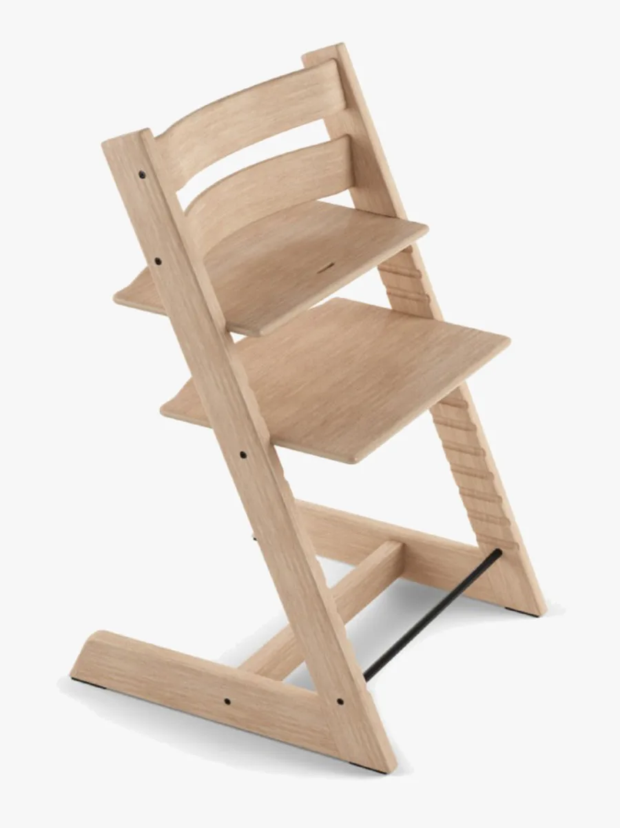 Stokke Tripp Trapp matstol i Oak Natural, sedd snett framifrån med justerbar sits och fotbräda